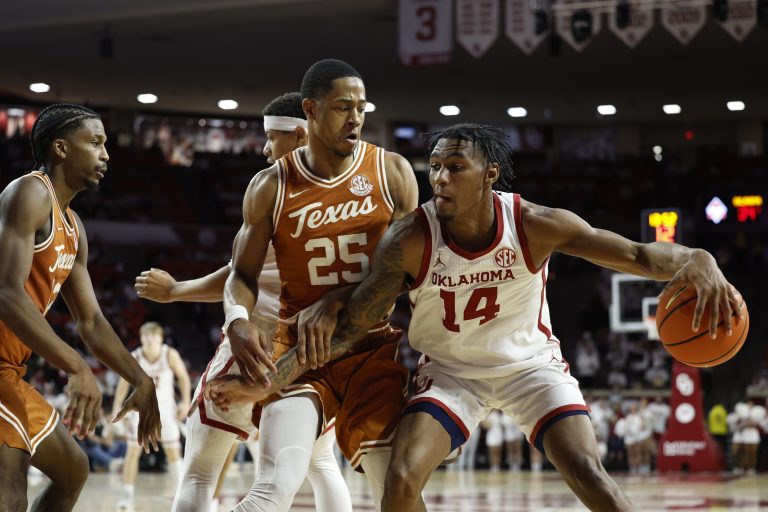 Oklahoma Sooners forward Jalon Moore (14) moves the ball against Texas Longhorns forward Jayson Kent (25) during the second half at Lloyd Noble Center.