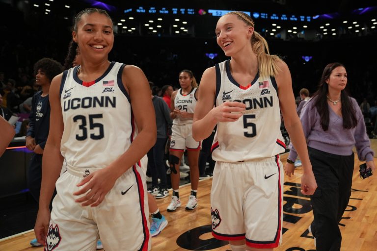 Connecticut Huskies guard Azzi Fudd (35) and Connecticut Huskies guard Paige Bueckers (5) celebrate after the game against the Louisville Cardinals at Barclays Center.