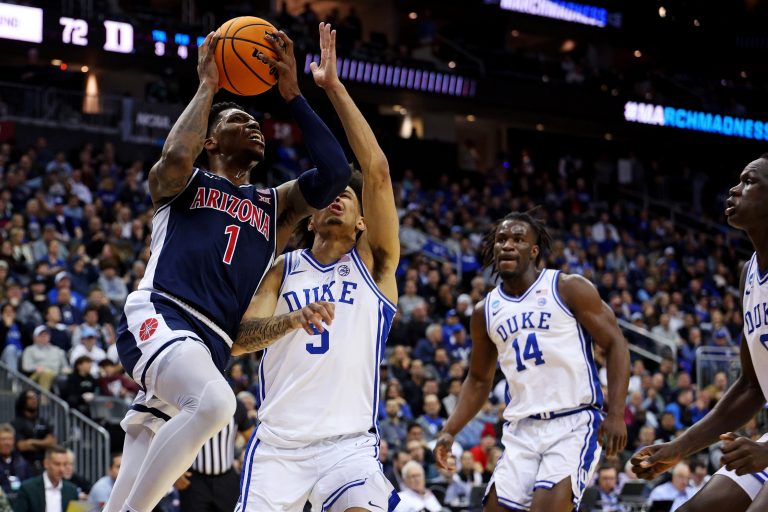 Arizona Wildcats guard Caleb Love (1) shoots the ball against Duke Blue Devils guard Tyrese Proctor (5) during the second half during an East Regional semifinal of the 2025 NCAA tournament at Prudential Center.