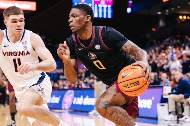 Florida State Seminoles guard Chandler Jackson (0) dribbles the ball as Virginia Cavaliers guard Isaac McKneely (11) defends in the first half at John Paul Jones Arena.