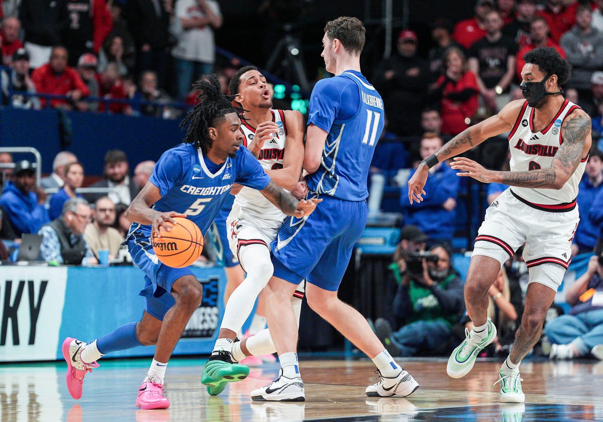 Louisville Cardinals forward Khani Rooths (9) runs into a hard pick by Creighton Bluejays center Ryan Kalkbrenner (11) as Creighton Bluejays guard Jamiya Neal (5) drives around in the first round game of the 2025 NCAA men's basketball tournament at Rupp Arena in Lexington, Kentucky Thursday March 20, 2025.