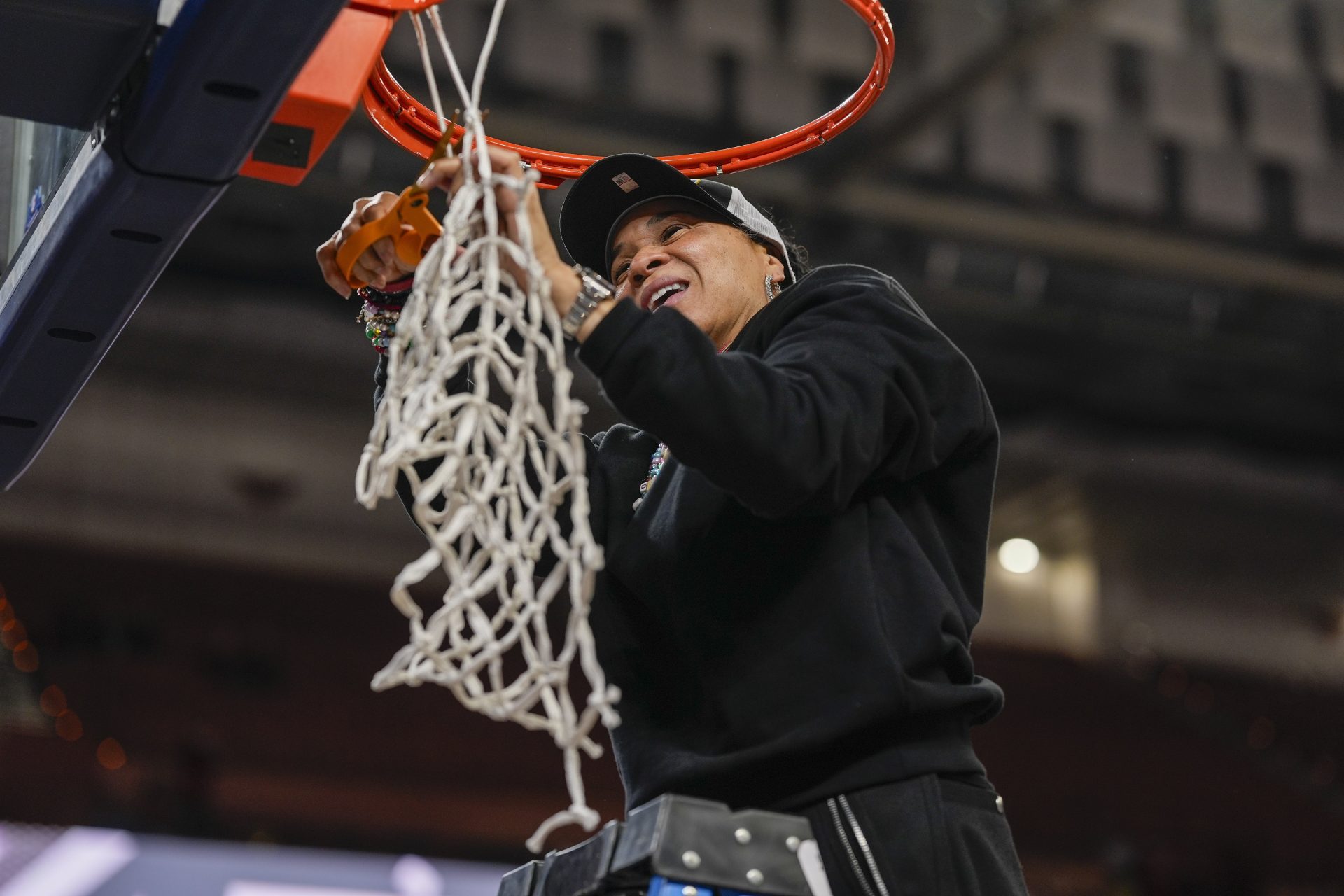 South Carolina Gamecocks head coach Dawn Staley cuts the net down after the win over Texas in the SEC womens championship at Bon Secours Wellness Arena.