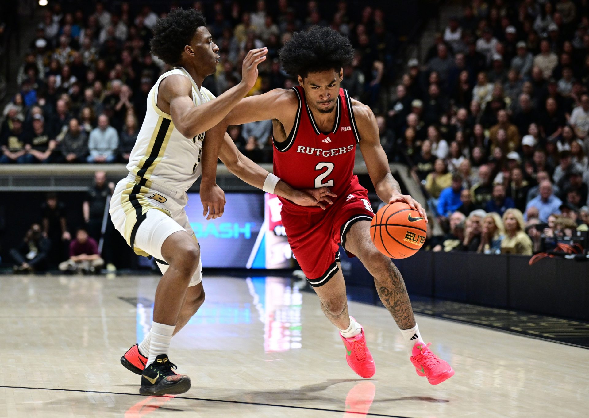 Rutgers Scarlet Knights guard Dylan Harper (2) drives the ball past Purdue Boilermakers forward Trey Kaufman-Renn (4) during the first half at Mackey Arena.