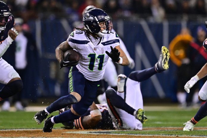 Seattle Seahawks wide receiver Jaxon Smith-Njigba (11) runs after a catch against the Chicago Bears during the third quarter at Soldier Field.