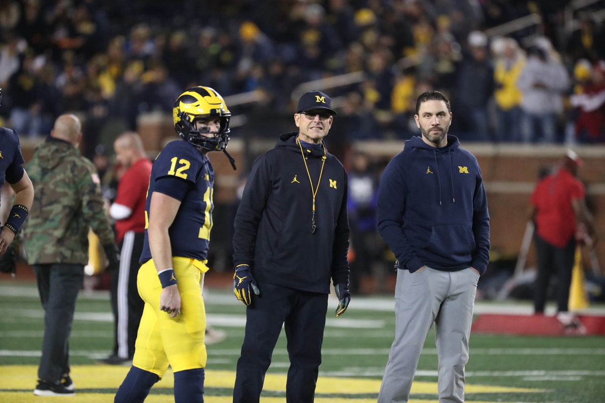 Michigan Wolverines head coach Jim Harbaugh, center, quarterbacks coach Matt Weiss, right, and quarterback Cade McNamara during warmups before action against the Indiana Hoosiers, Saturday, Nov. 6, 2021 at Michigan Stadium.