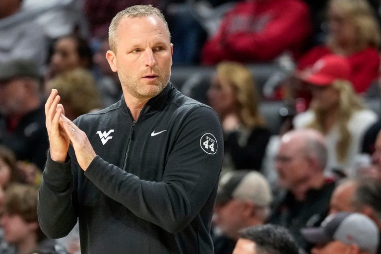 West Virginia Mountaineers head coach Darian DeVries applauds his defense in the first half of the NCAA basketball game between the Cincinnati Bearcats and the West Virginia Mountaineers at Fifth Third Arena in Cincinnati on Sunday, Feb. 2, 2025.