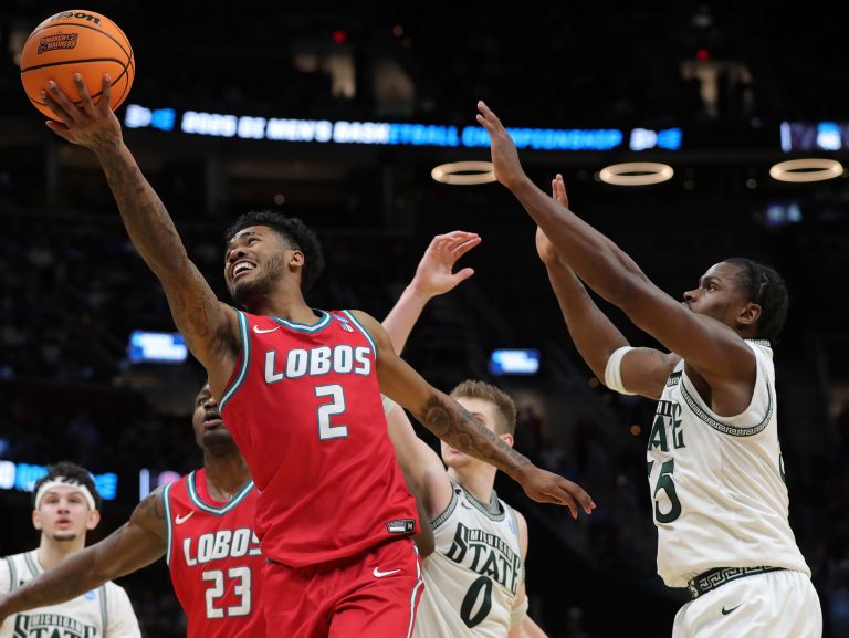 New Mexico Lobos guard Donovan Dent (2) shoots a layup in front of Michigan State Spartans forward Coen Carr (55) during the second half of an NCAA Tournament Second Round game at Rocket Arena on Sunday, March 23, 2025, in Cleveland, Ohio.