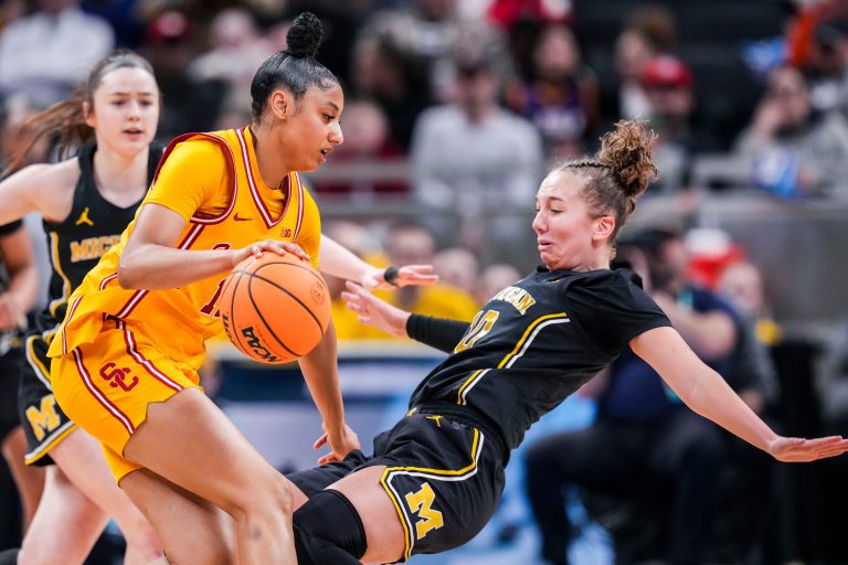 Michigan Wolverines guard Jordan Hobbs (10) takes a charge from USC Trojans guard JuJu Watkins (12) on Saturday, March 8, 2025, in a semifinals game at the 2025 TIAA Big Ten Women's Basketball Tournament between the Iowa Hawkeyes and the Ohio State Buckeyes at Gainbridge Fieldhouse in Indianapolis.