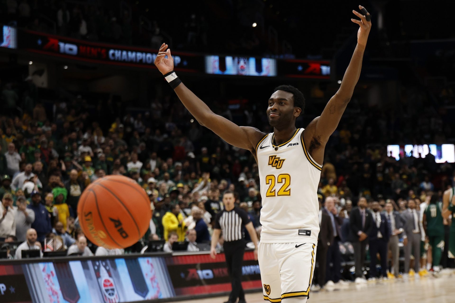 VCU Rams guard Joe Bamisile (22) celebrates after making free throws with 0.5 seconds being added back onto the clock against the George Mason Patriots in the second half at Capital One Arena.