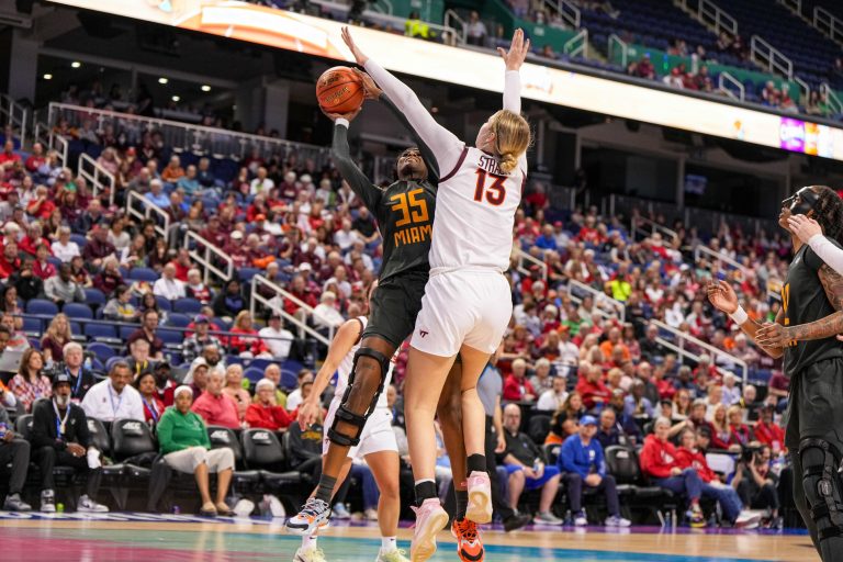 Miami Hurricanes forward Latasha Lattimore (35) shoots the ball over Virginia Tech Hokies center Clara Strack (13) in the second half at Greensboro Coliseum.
