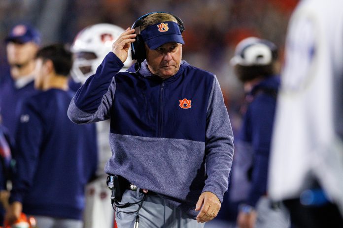 Auburn Tigers head coach Hugh Freeze walks onto the field during a timeout in the first quarter against the Kentucky Wildcats at Kroger Field.