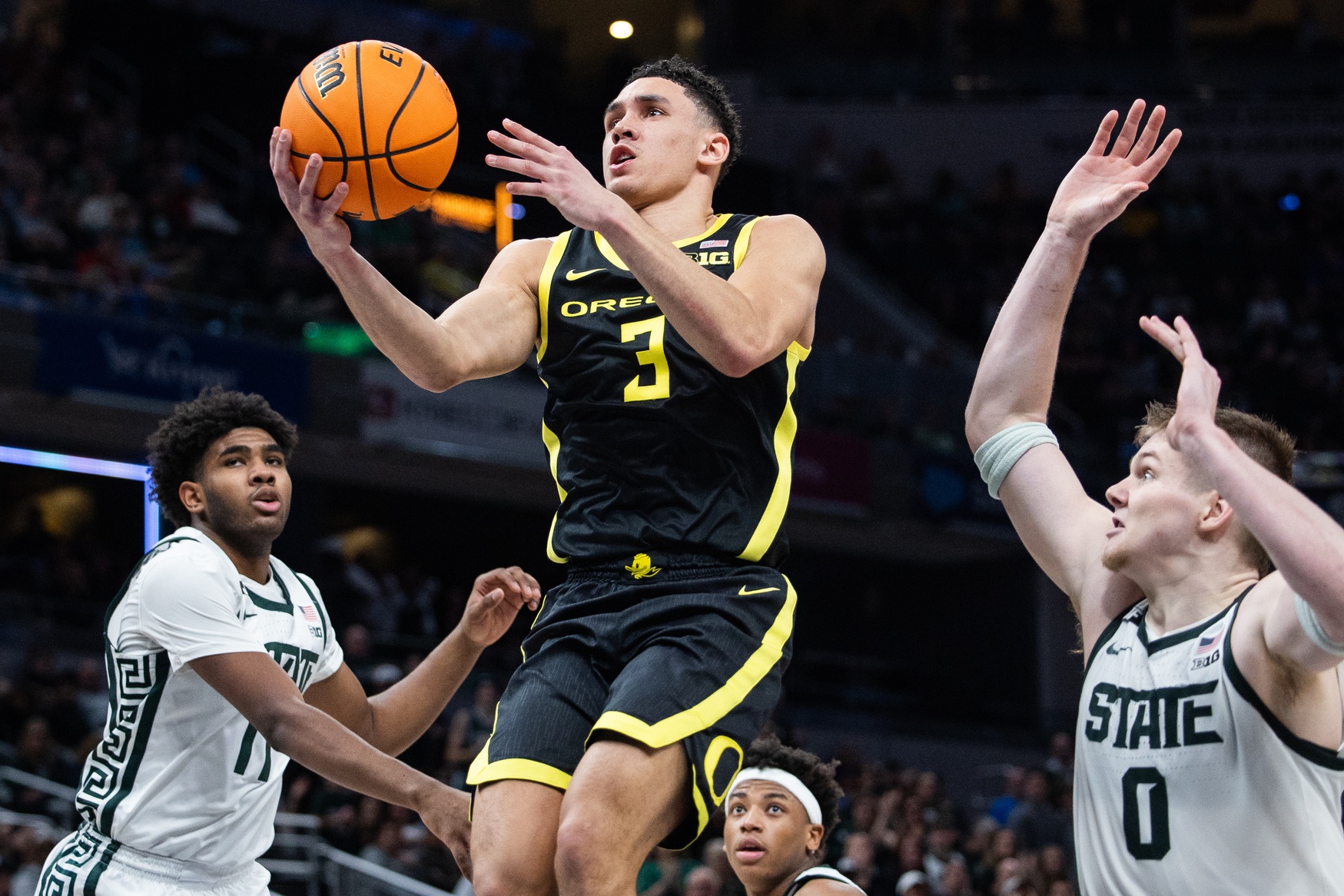 Oregon Ducks guard Jackson Shelstad (3) shoots the ball while Michigan State Spartans guard Jase Richardson (11) defends in the second half at Gainbridge Fieldhouse.