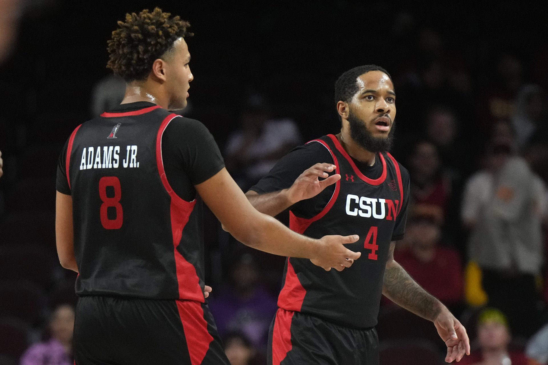 Cal State Northridge Matadors forward Marcus Adams Jr. (8) and guard PJ Fuller II (4) react in the first half against the Southern California Trojans at Galen Center.