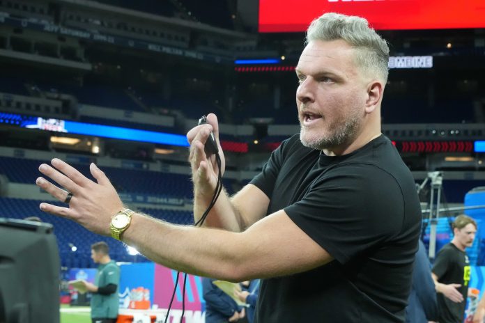 Pat McAfee watches workouts at the 2025 NFL Scouting Combine at Lucas Oil Stadium.