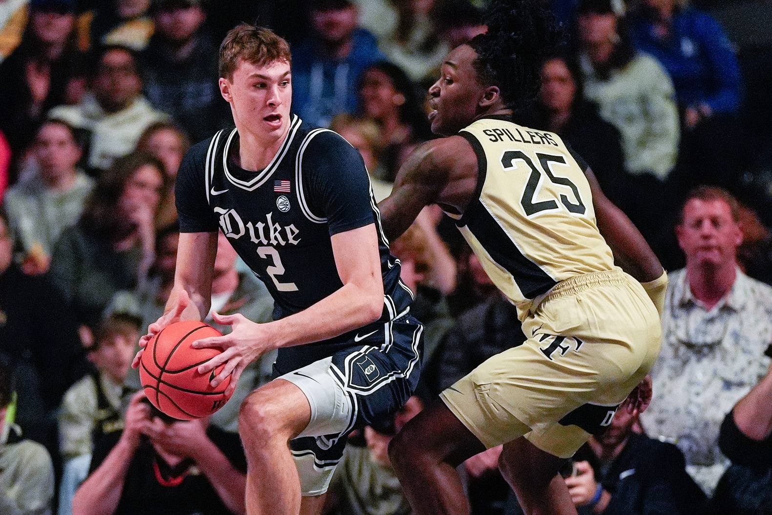 Duke Blue Devils guard Cooper Flagg (2) handles the ball against Wake Forest Demon Deacons forward Tre'Von Spillers (25) at Lawrence Joel Veterans Memorial Coliseum.