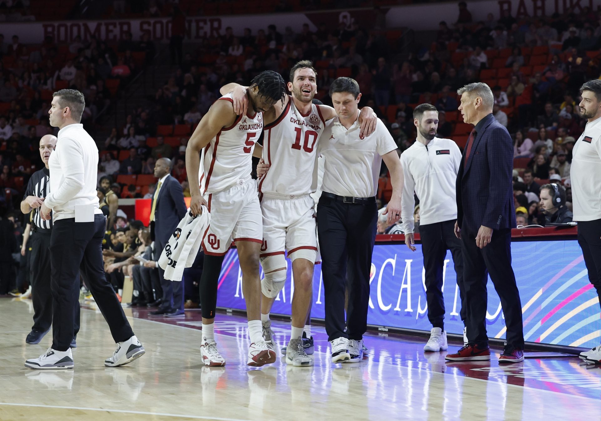 Oklahoma Sooners forward Sam Godwin (10) is helped off the court after a fall during a play against the Missouri Tigers during the first half at Lloyd Noble Center.