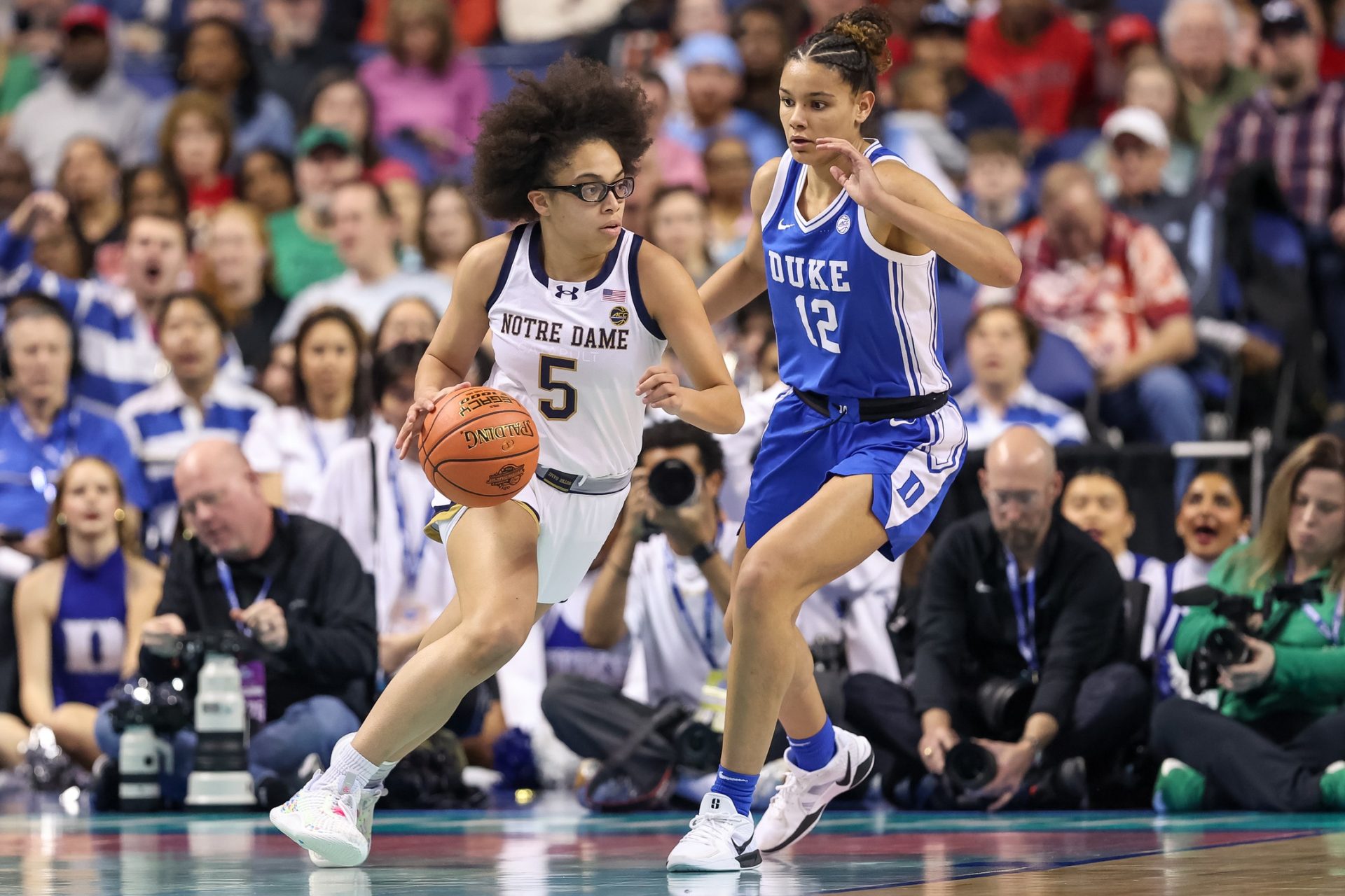 Notre Dame Fighting Irish guard Olivia Miles (5) moves the ball around Duke Blue Devils forward Delaney Thomas (12) during the first quarter at First Horizon Coliseum.