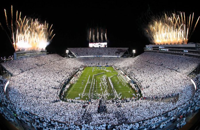 Fireworks burst overhead as the Penn State Nittany Lions take the field prior to a White Out game against the Washington Huskies at Beaver Stadium.