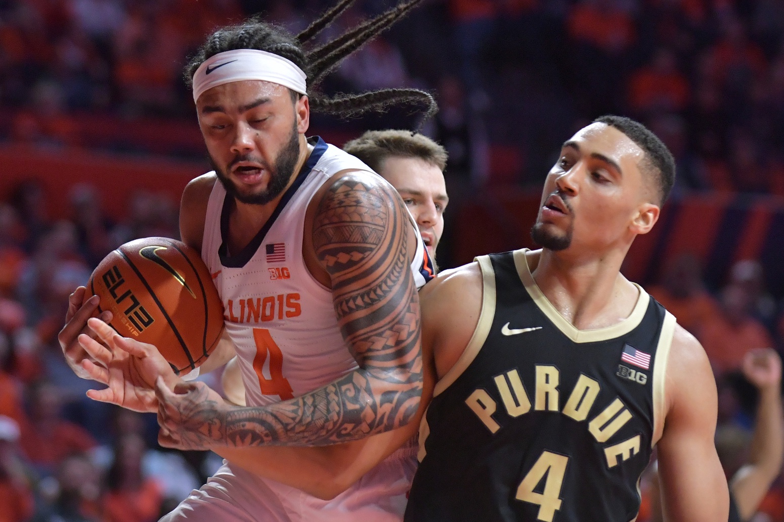 Illinois Fighting Illini guard Kylan Boswell (4) drives the ball as Purdue Boilermakers forward Trey Kaufman-Renn (4) reaches in during the second half at State Farm Center.