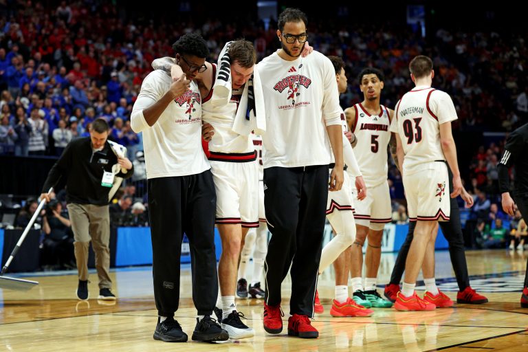 Louisville Cardinals guard Reyne Smith (6) is helped off the court after being injured during the second half against the Louisville Cardinals in the first round of the NCAA Tournament at Rupp Arena.