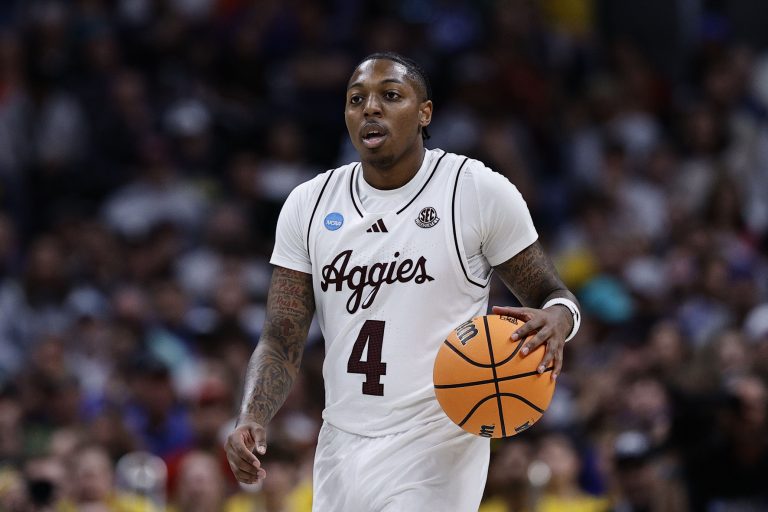 Texas A&M Aggies guard Wade Taylor IV (4) dribbles the ball against the Michigan Wolverines during the second half in the second round of the NCAA Tournament at Ball Arena.