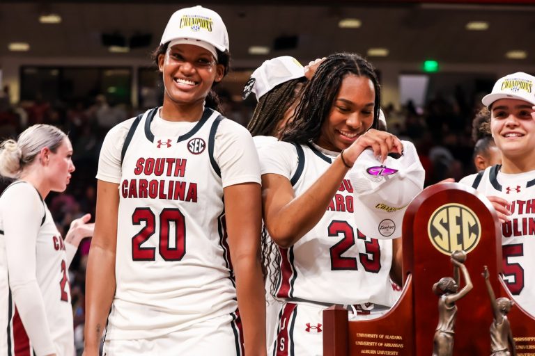 South Carolina Gamecocks forward Sania Feagin (20) and guard Bree Hall (23) try on SEC Championship hats after defeating the Kentucky Wildcats at Colonial Life Arena.