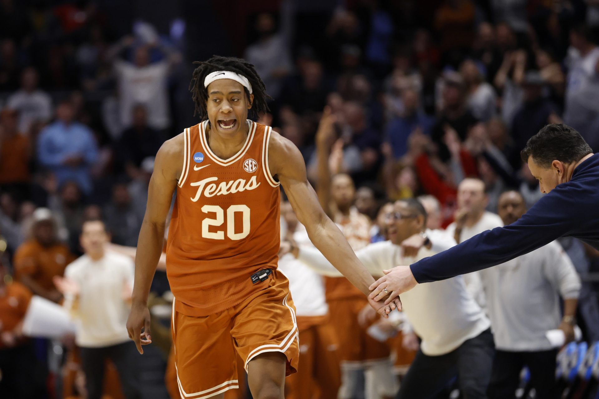 Texas Longhorns guard Tre Johnson (20) high fives Xavier Musketeers head coach Sean Miller after making a three point basket in the second half at UD Arena.