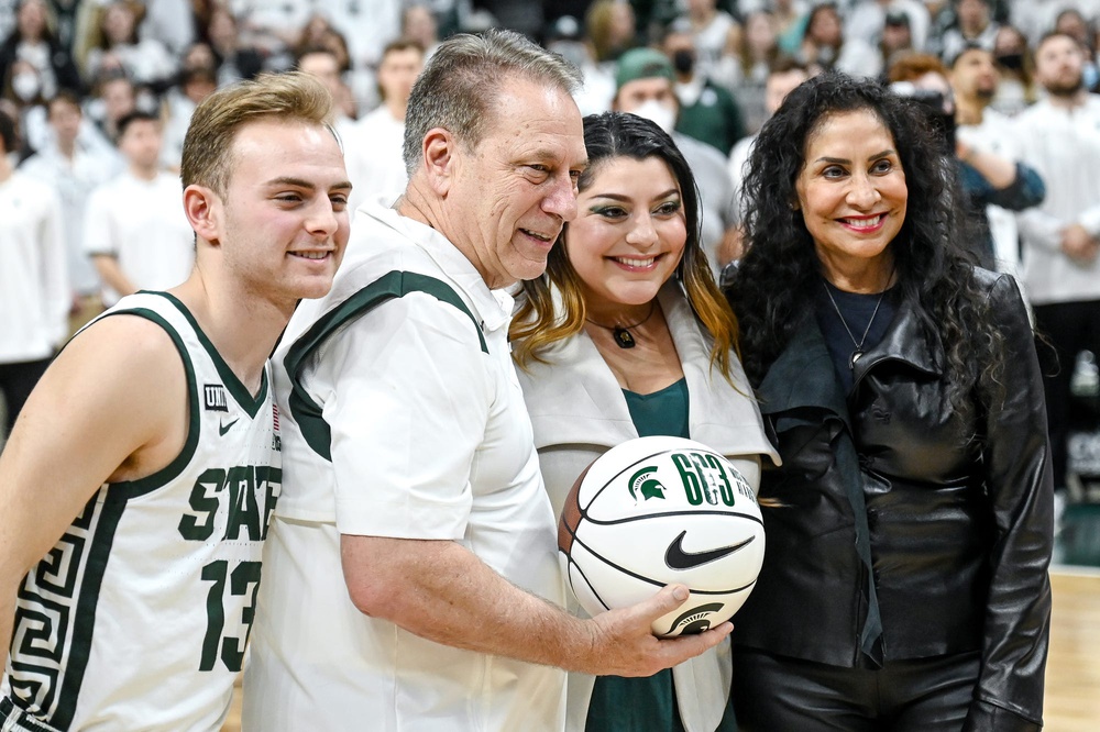 Michigan State's head coach Tom Izzo, center, poses for a photo with his family after the game against Maryland