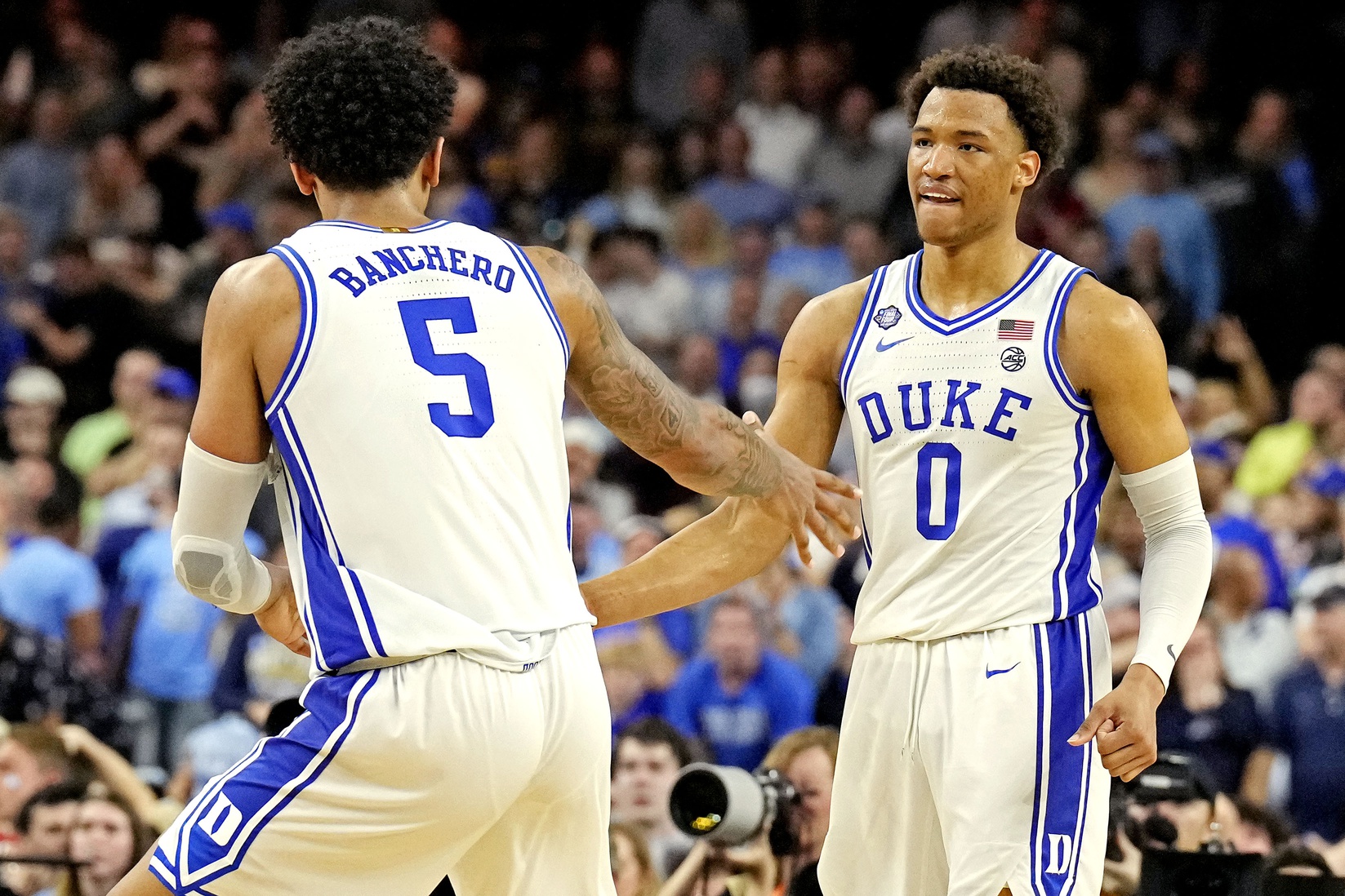 Duke Blue Devils forward Paolo Banchero (5) and forward Wendell Moore Jr. (0) celebrates after a play during the second half against the North Carolina Tar Heels in the 2022 NCAA men's basketball tournament Final Four semifinals at Caesars Superdome.