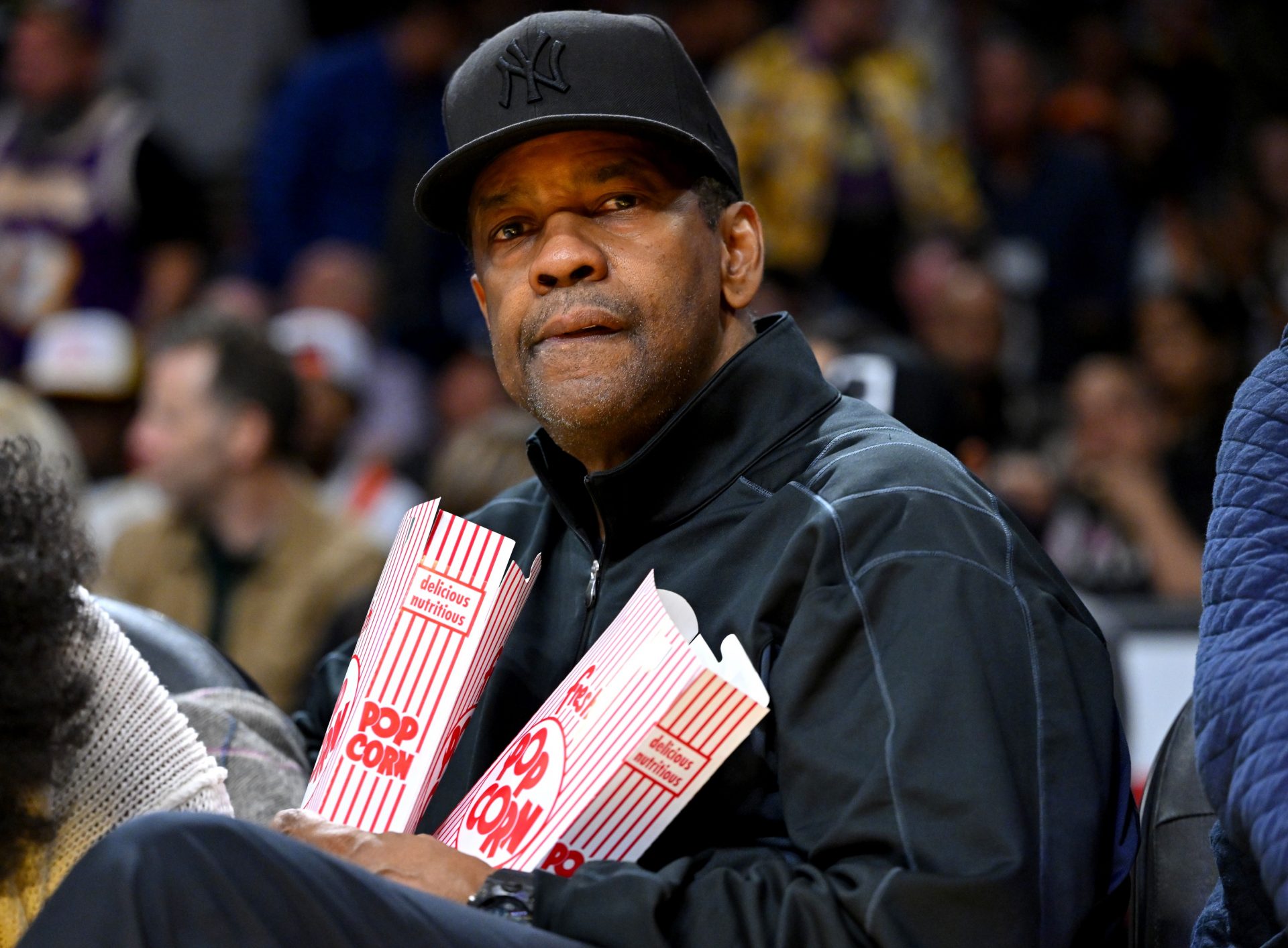 Actor and filmmaker Denzel Washington watches the game between the Los Angeles Lakers and the Milwaukee Bucks at Crypto.com Arena.