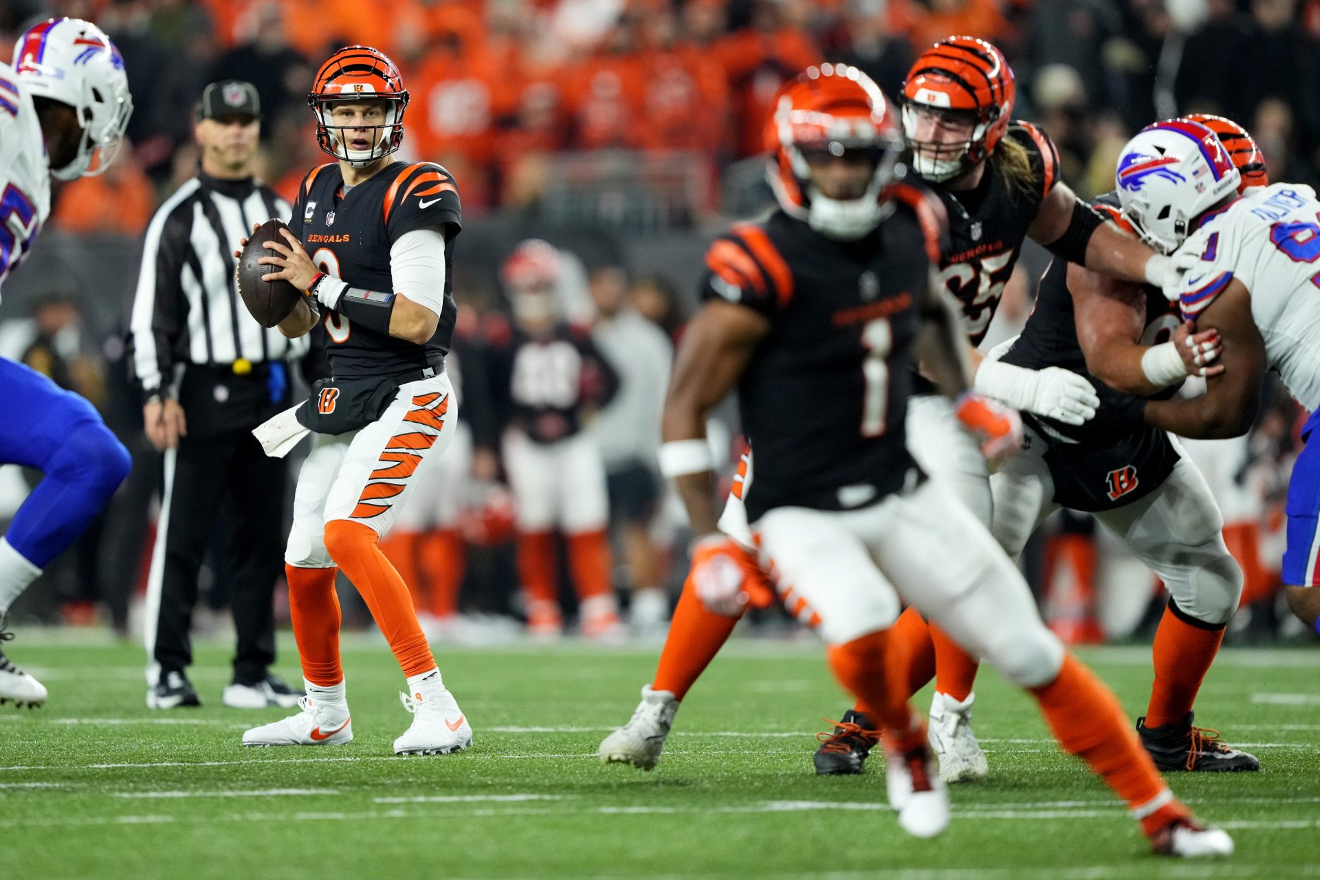 Cincinnati Bengals quarterback Joe Burrow (9) look toward wide receiver Ja'Marr Chase (1) while he runs a route in the fourth quarter against the Buffalo Bills at Paycor Stadium.