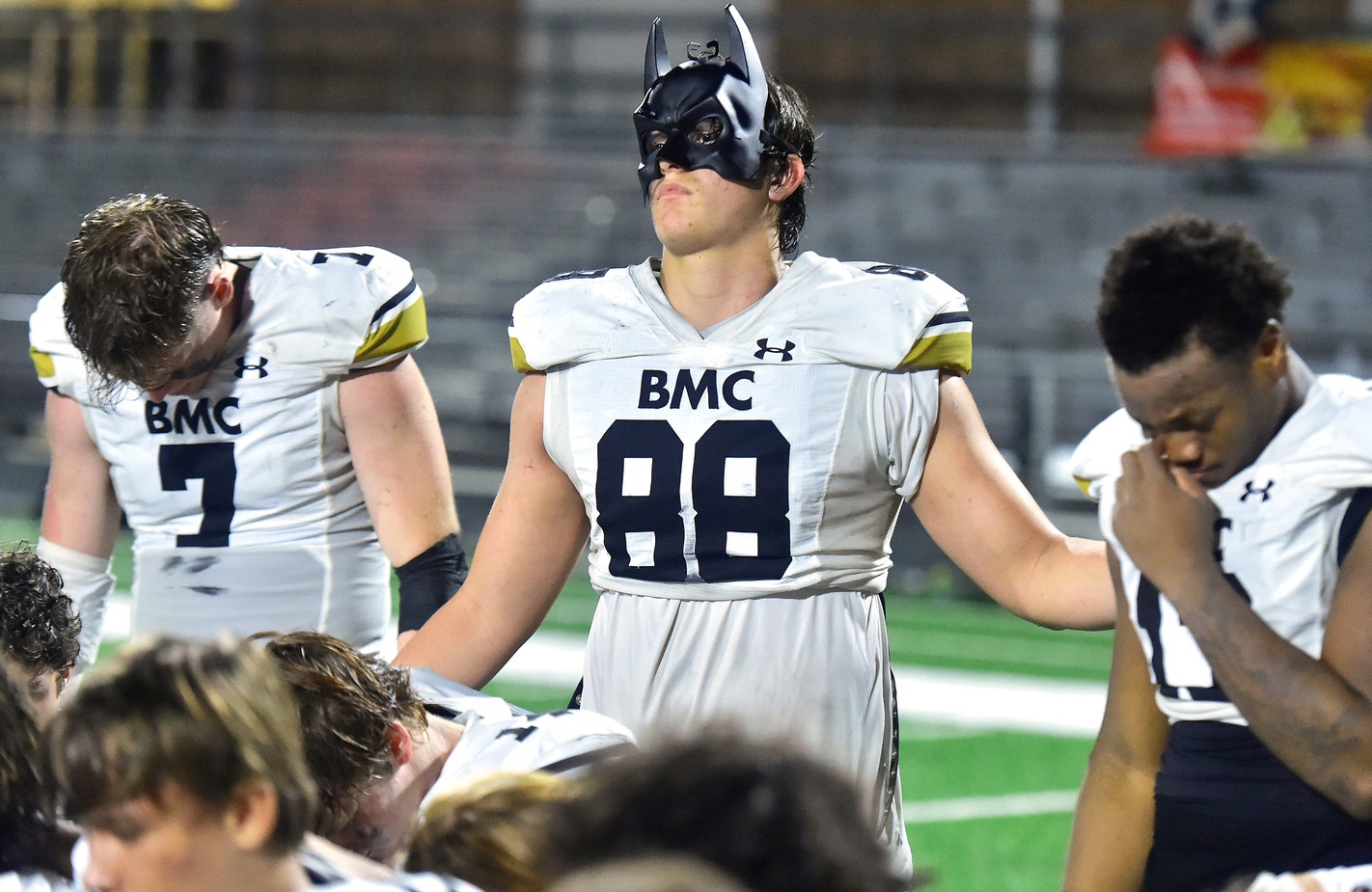 Bishop Moore's Jake Kreul (88) wears his batman mask as he and teammates gather after Friday night's 37 to 35 victory over the Riverside Generals. OrlandoÕs Bishop Moore High School traveled to JacksonvilleÕs Riverside High School for the Class 3M football Playoffs Friday, November 17, 2023. The Riverside Generals trailed 22 to 13 at the half and battled back in the second half but fell short, ending their season with a 37 to 35 loss to the Bishop Moore Hornets.