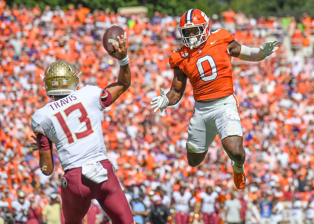 Clemson linebacker Barrett Carter (0) pressures Florida State University quarterback Jordan Travis (13) during the fourth quarter Sep 23, 2023; Clemson, South Carolina, USA; at Memorial Stadium.