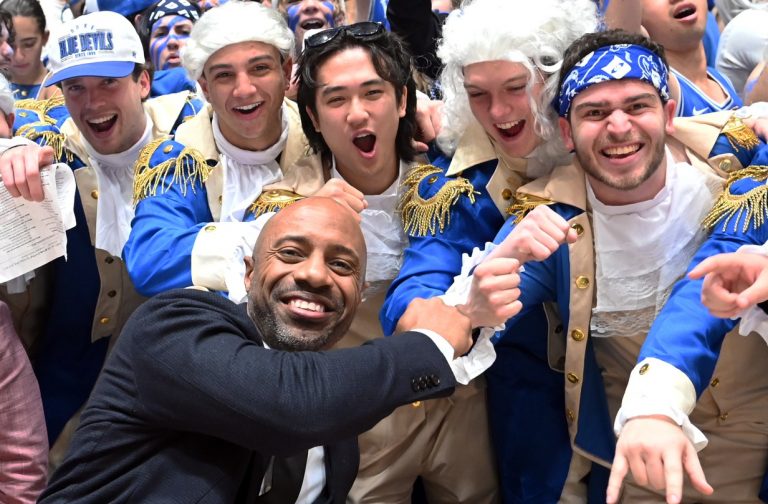 ESPN basketball commentator Jay Williams (front left) greets Duke students prior to a game between the North Carolina Tar Heels and the Duke Blue Devils at Cameron Indoor Stadium.