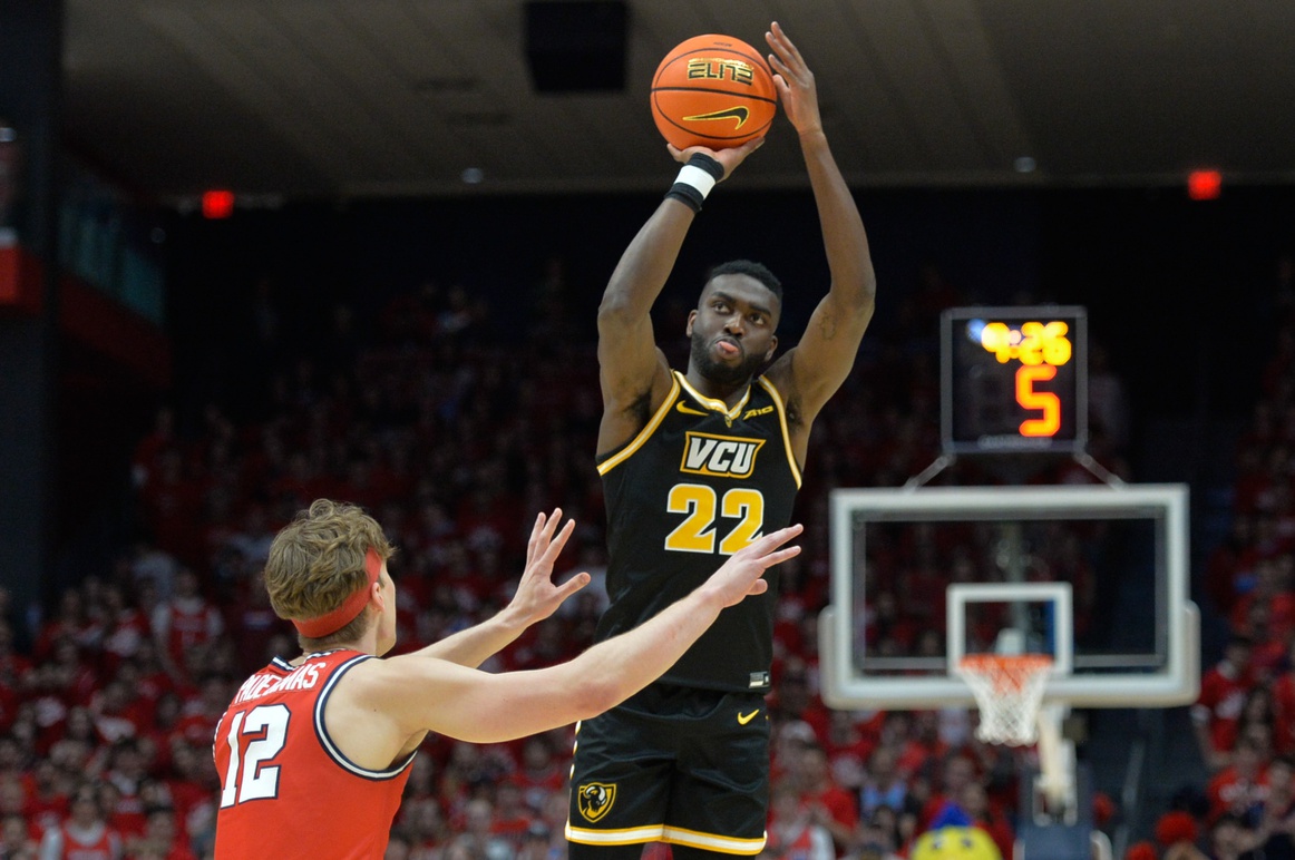 Virginia Commonwealth Rams guard Joe Bamisile (22) shoots the ball against Dayton Flyers forward Petras Padegimas (12) during the first half of the game at University of Dayton Arena.