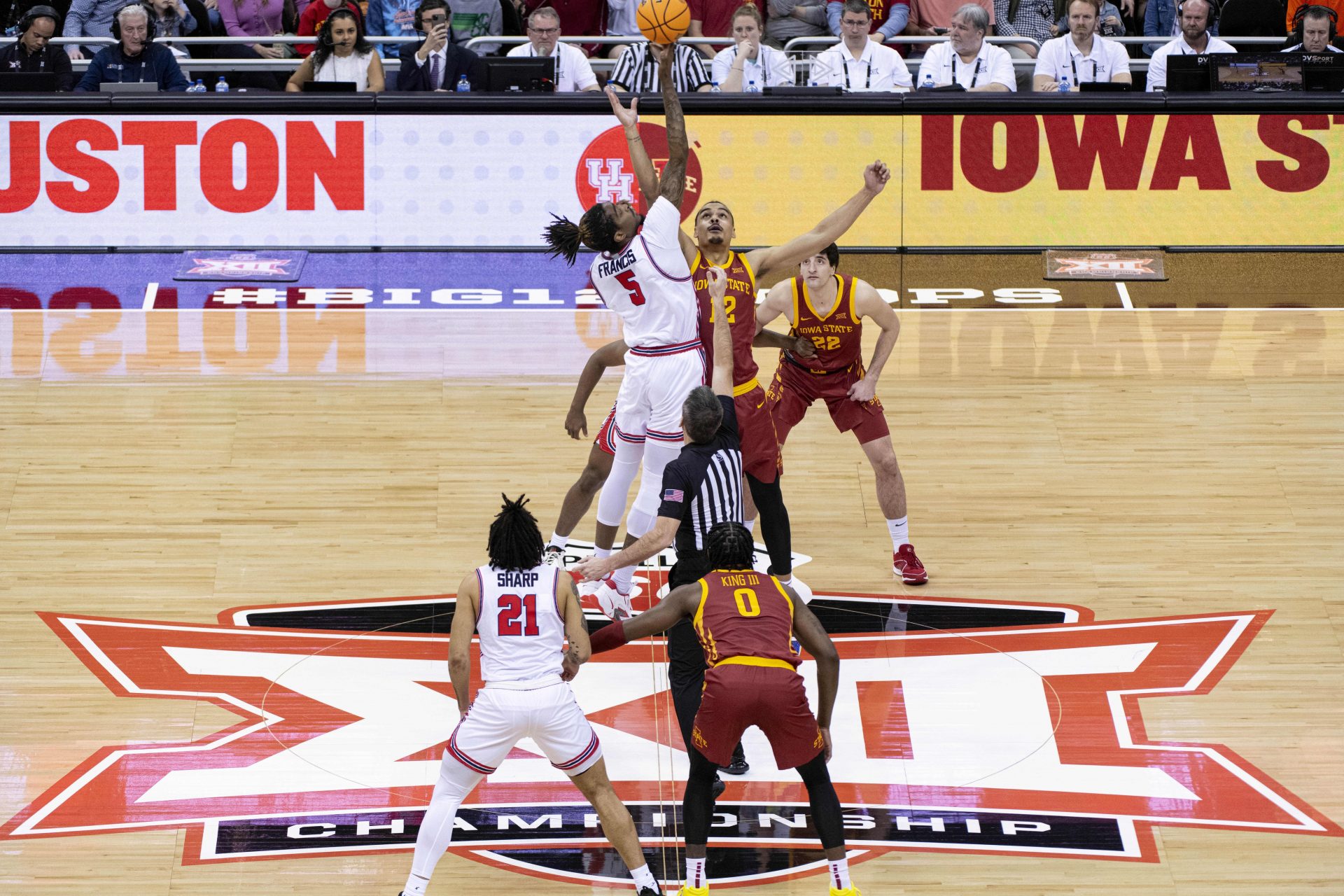 Houston Cougars forward Ja'Vier Francis (5) and Iowa State Cyclones forward Robert Jones (12) face each other in the tip-off in the first half at T-Mobile Center.