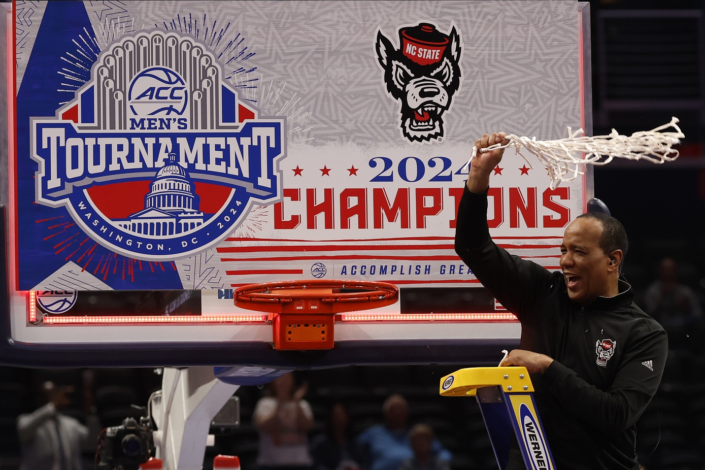 North Carolina State Wolfpack head coach Kevin Keatts reacts by cutting the net after defeating the North Carolina Tar Heels at Capital One Arena.