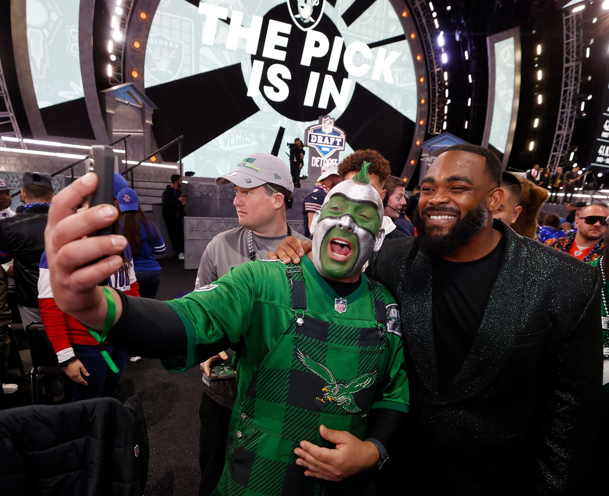 51 of Philadelphia, uses FaceTime on his iPhone with Eagles player and former Michigan football player Brandon Graham