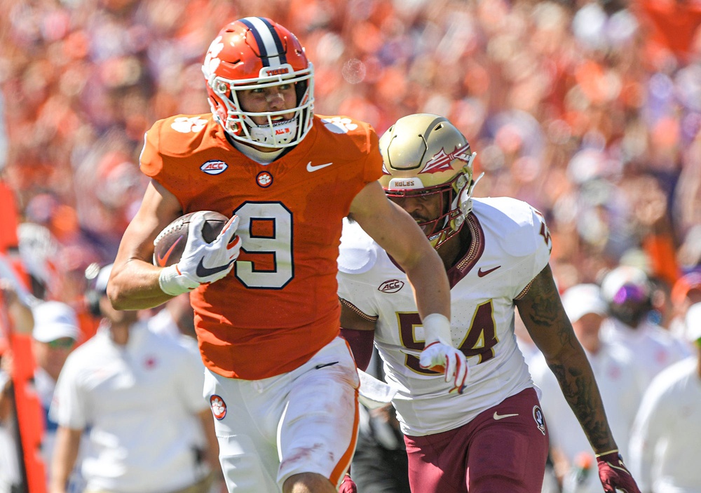 Clemson tight end Jake Briningstool (9) makes a catch near Florida State University defensive lineman Byron Turner Jr. (54) during the second quarter Sep 23, 2023; Clemson, South Carolina, USA; at Memorial Stadium.