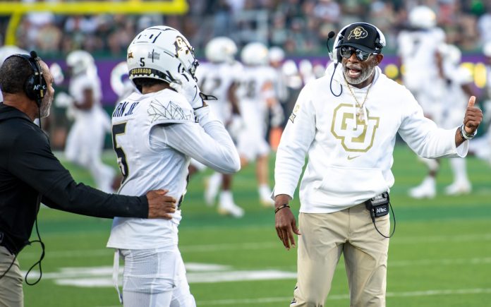 CU football head coach Deion Sanders, or Coach Prime, gives instruction to wide receiver Jimmy Horn Jr. (5) against CSU in the Rocky Mountain Showdown at Canvas Stadium on Saturday, Sept. 14, 2024, in Fort Collins, Colo.