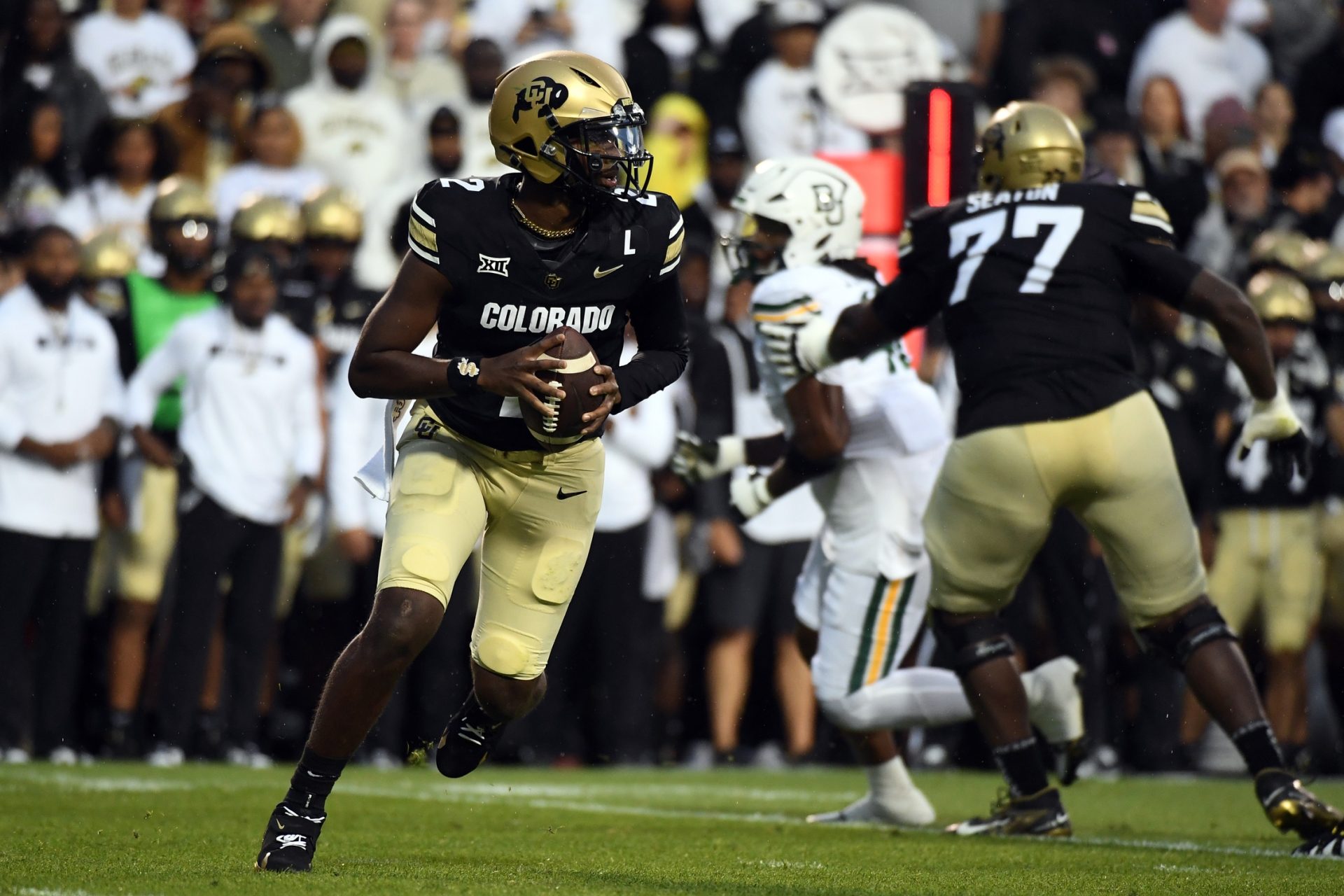 Colorado Buffaloes quarterback Shedeur Sanders (2) rolls out of the pocket on a play during the first half against the Baylor Bears