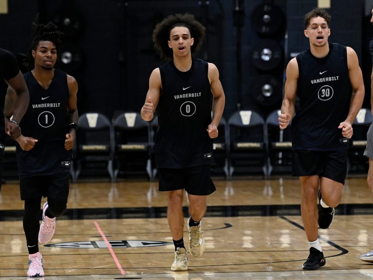 Karris Bilal (0) and Chris Manon (30) warm up during an NCAA college basketball practice Tuesday