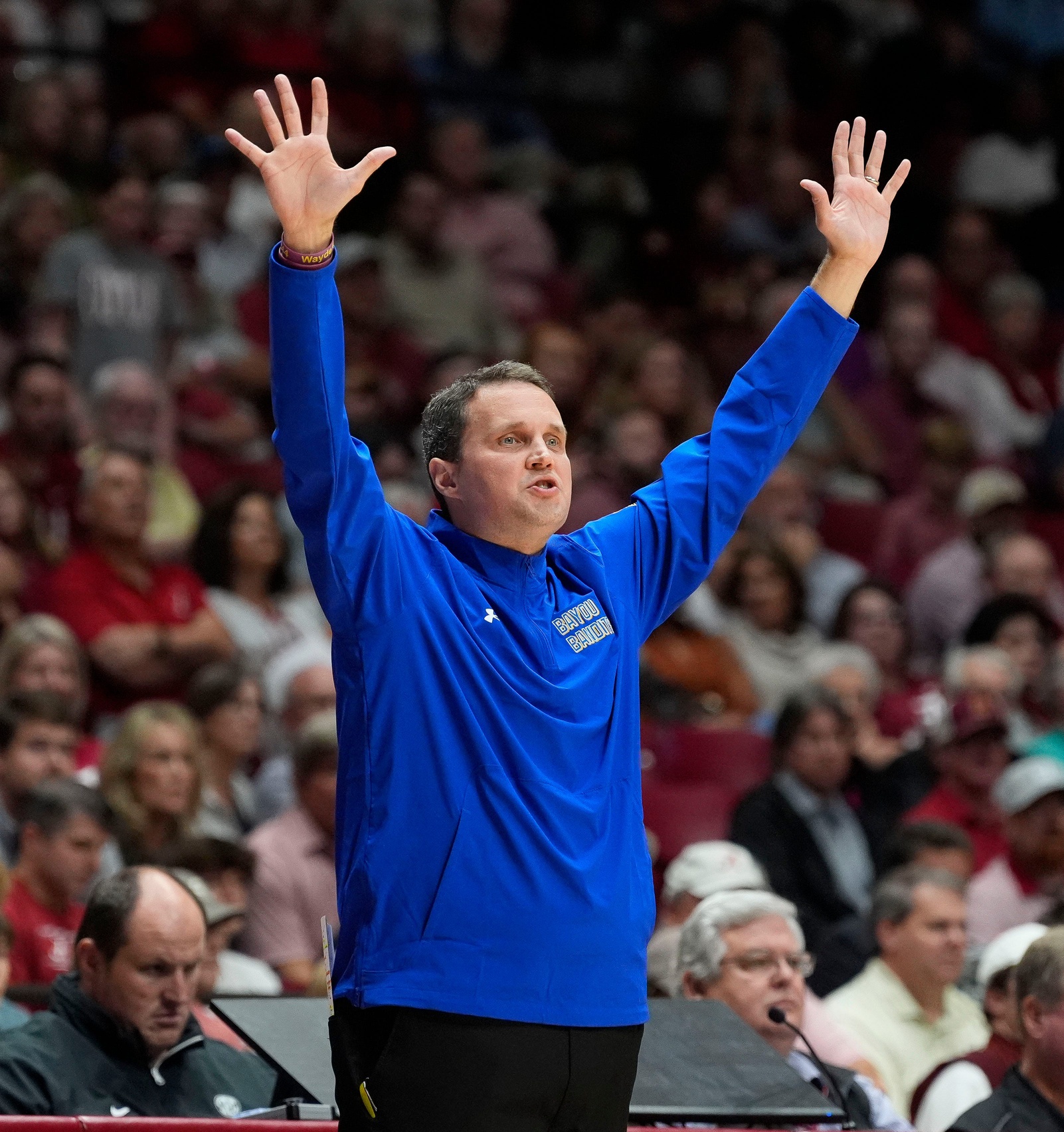 McNeese head coach Will Wade lifts his hands as he signals to his team during the game with Alabama at Coleman Coliseum.