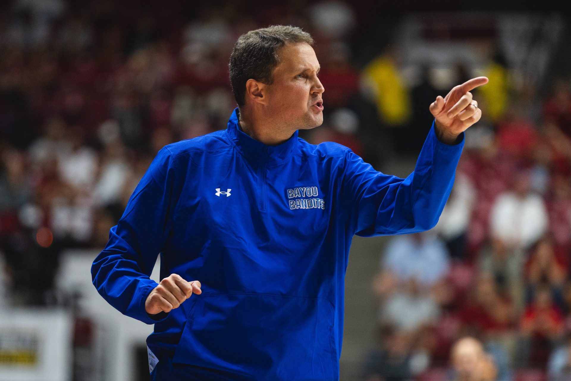 McNeese State Cowboys head coach Will Wade gives instructions to his players from the bench during the first half at Coleman Coliseum.