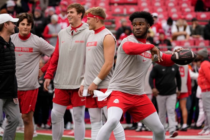 Air Noland (12) warms up prior to the NCAA football game against the Indiana