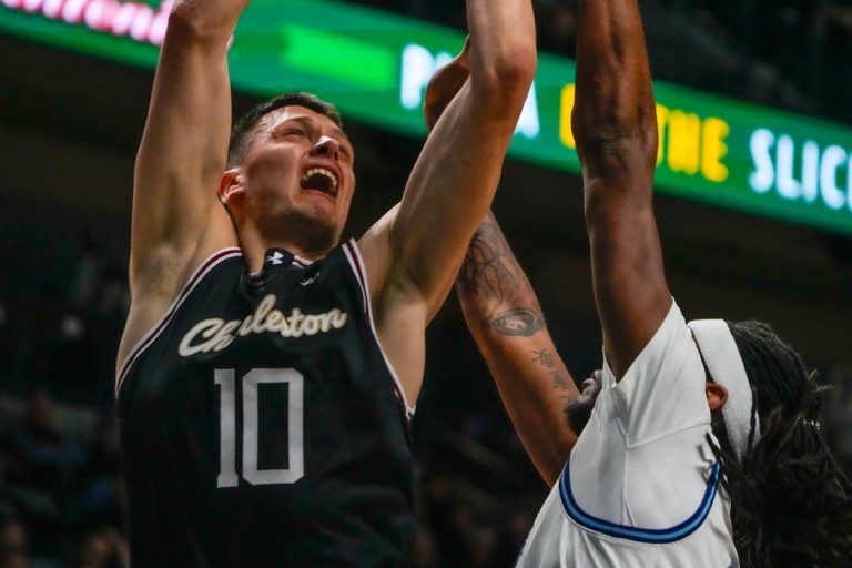 URI Rams basketball Beat Charleston. Ante Brzovic under net in first half action.