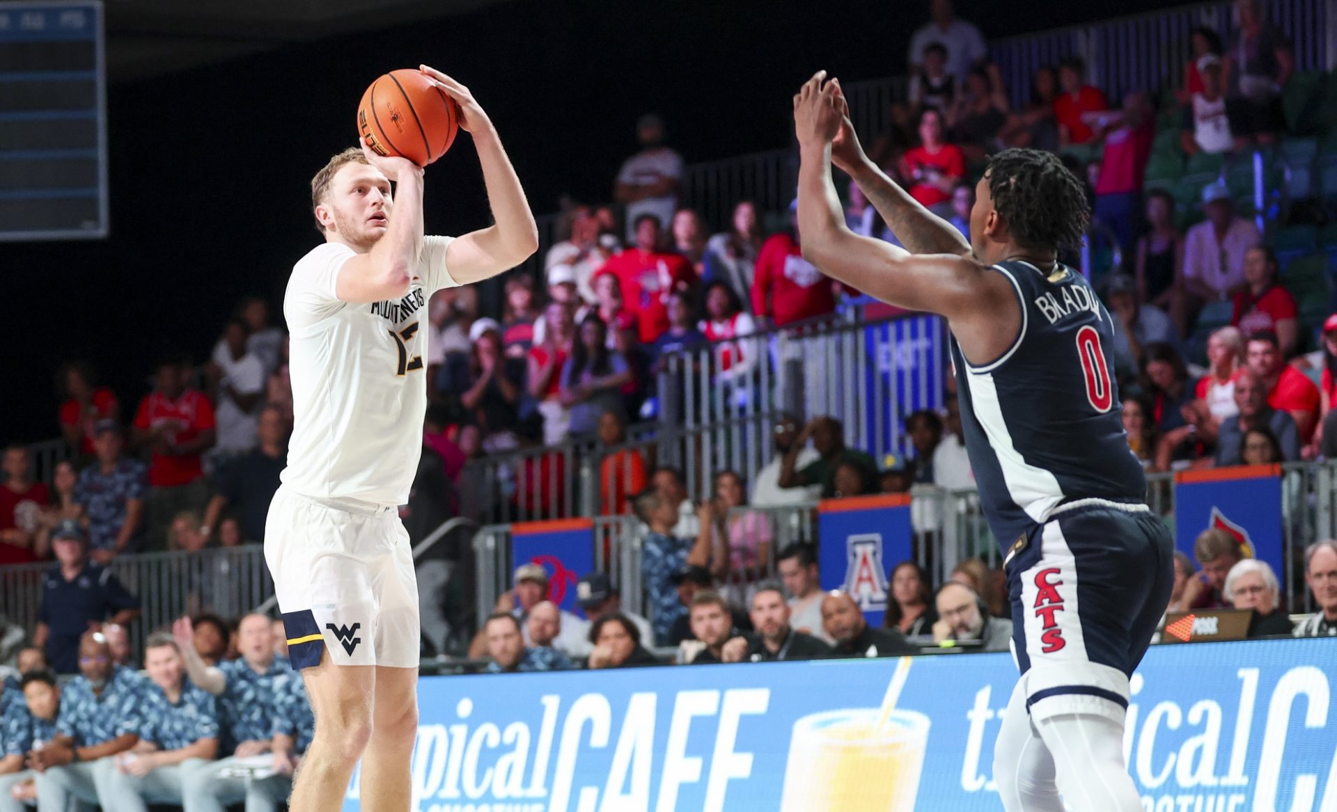 West Virginia Mountaineers guard Tucker DeVries (12) shoots over Arizona Wildcats guard Jaden Bradley (0) during the second half at Imperial Arena at the Atlantis resort.