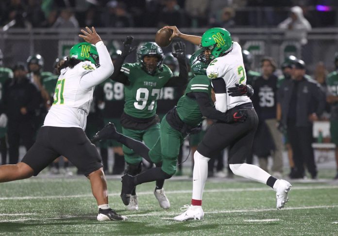 Pacifica's Nick Lavizzo drills Narbonne quarterback Jaden O'Neal during the second quarter of the CIF-State Division 2AA regional championship game at Pacifica High on Friday, Dec. 6, 2024. The Tritons won 37-20 to advance to the state championship.