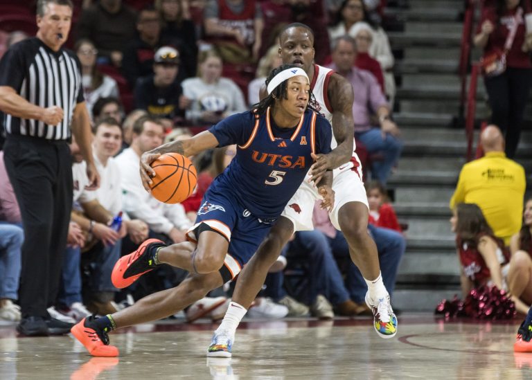 Texas-San Antonio Roadrunners forward Raekwon Horton (5) drives around Arkansas Razorbacks guard Johnell Davis (1) during the second half at Bud Walton Arena.