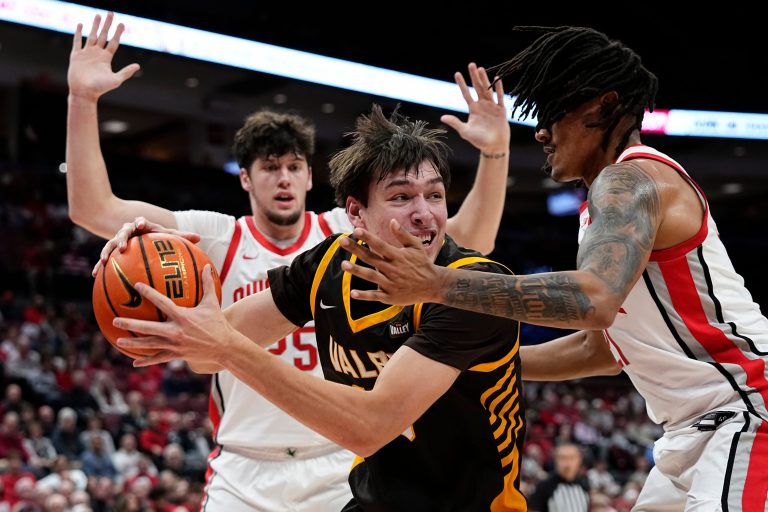 Ohio State Buckeyes forward Devin Royal (21) defends Valparaiso Beacons forward Cooper Schwieger (13) during the during the first half of the NCAA men's basketball game at Value City Arena in Columbus on Dec. 17, 2024.